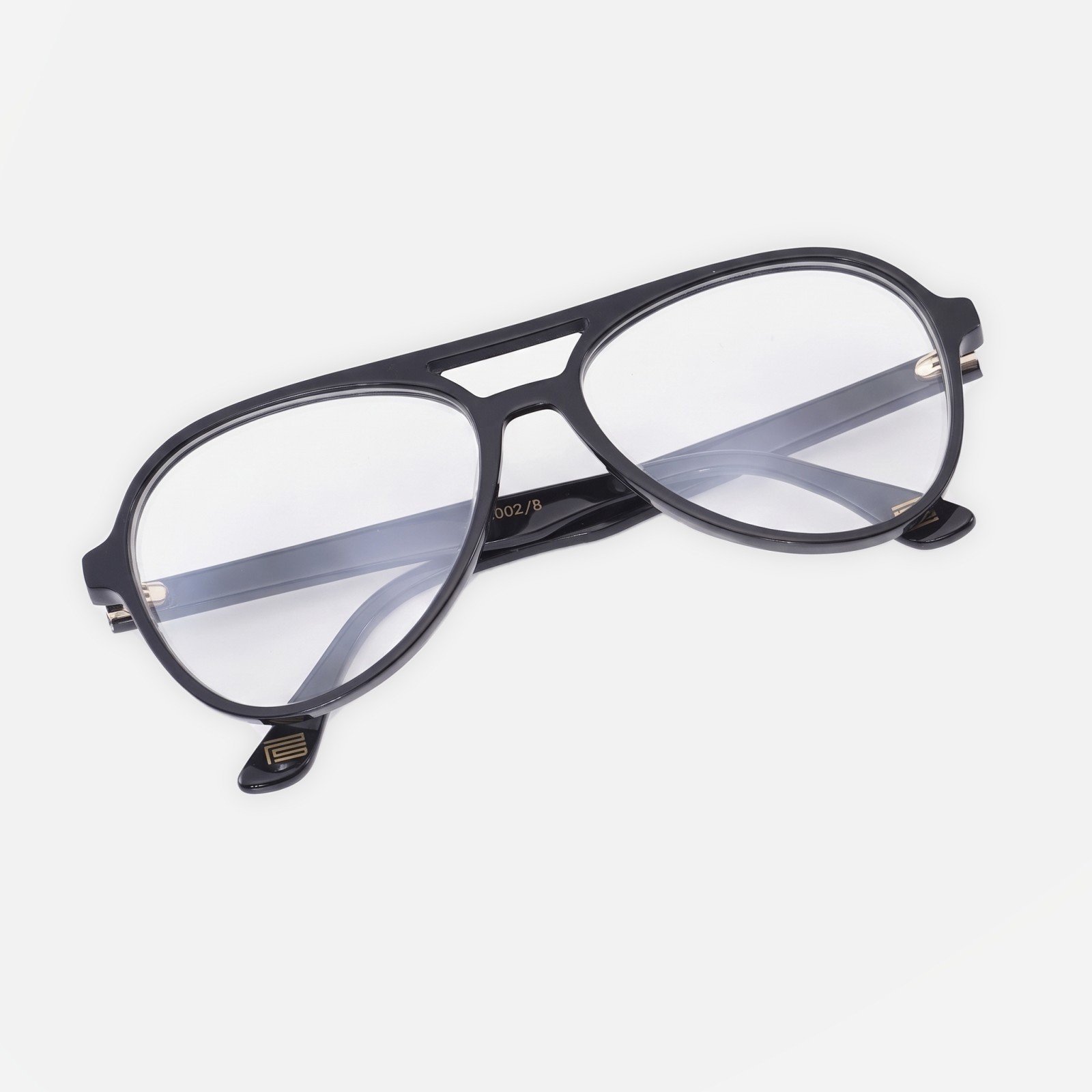 The Aviator in Noir, with clear prescription lenses, slotted bridge and the gold PS mark