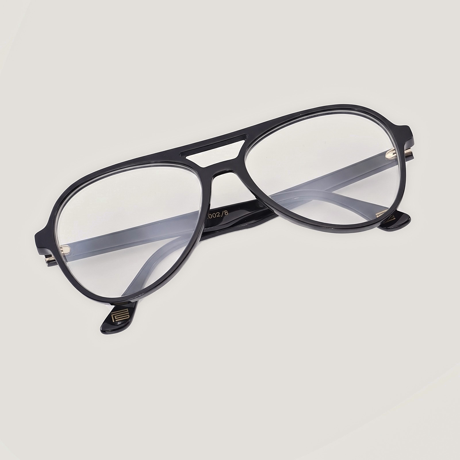 The Aviator in Noir, with clear prescription lenses, slotted bridge and the gold PS mark
