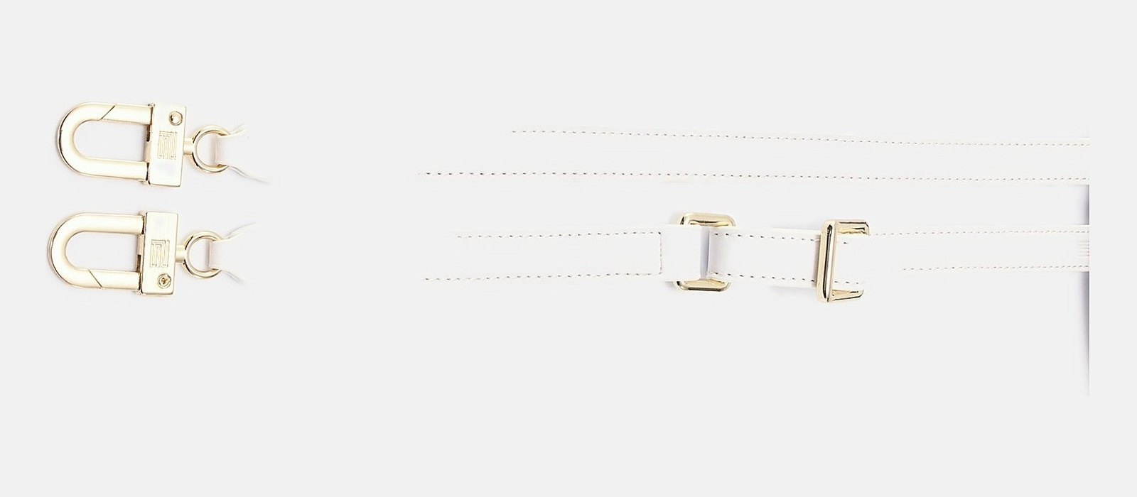The slim crossbody strap in the matching vegan leather, solid brass clips