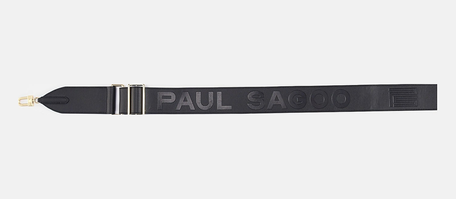 The wide PAUL SAGOO-embossed shoulder strap, solid brass clips