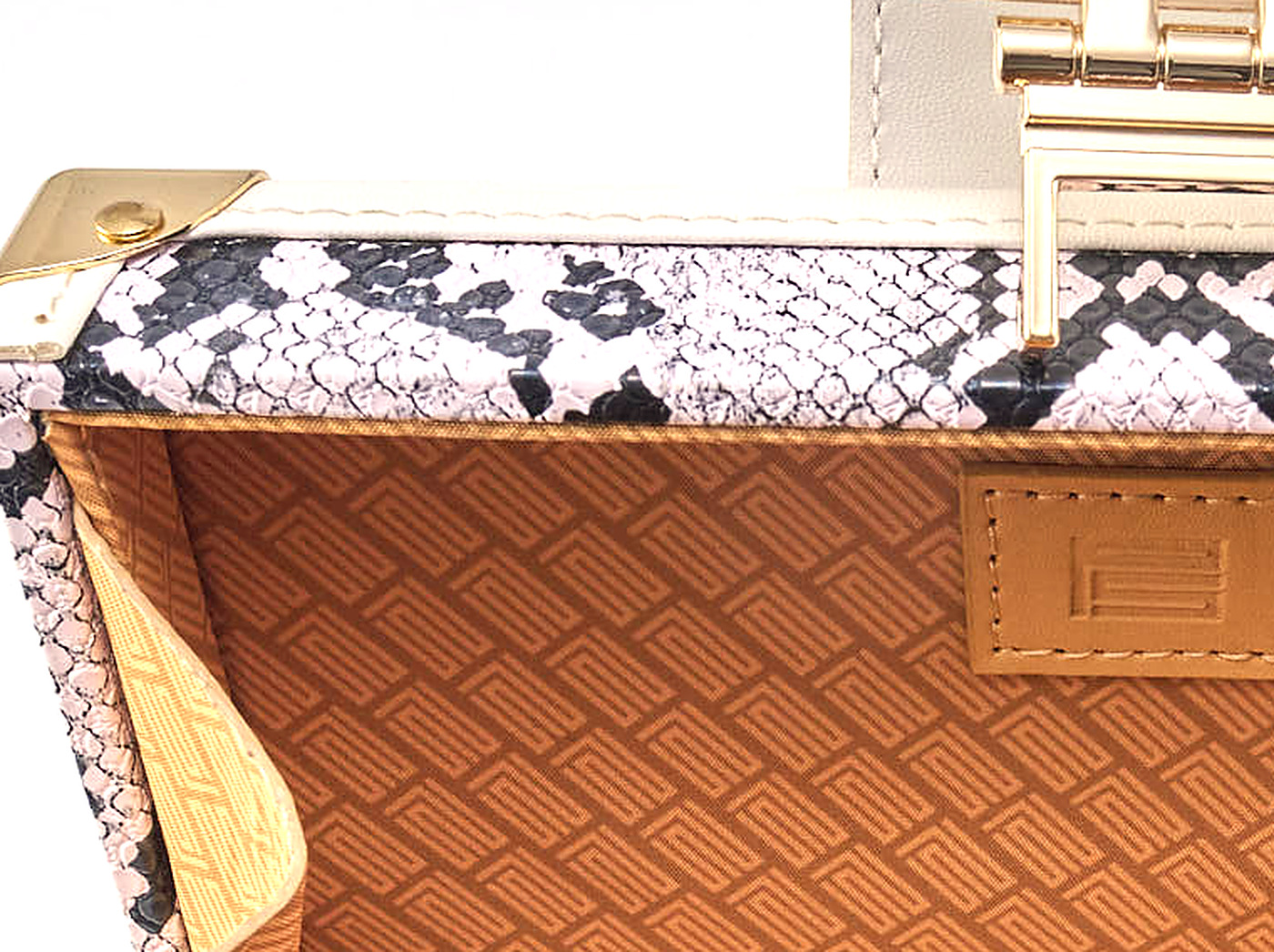 The monogram embossed across the tan lining of the Coffret Python print