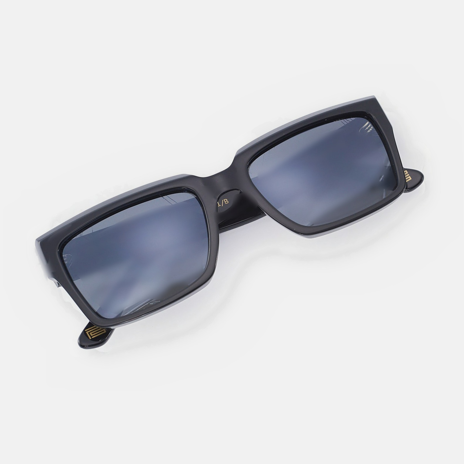 The Square PS001/B — chamfered black acetate, gold PS temple plaque