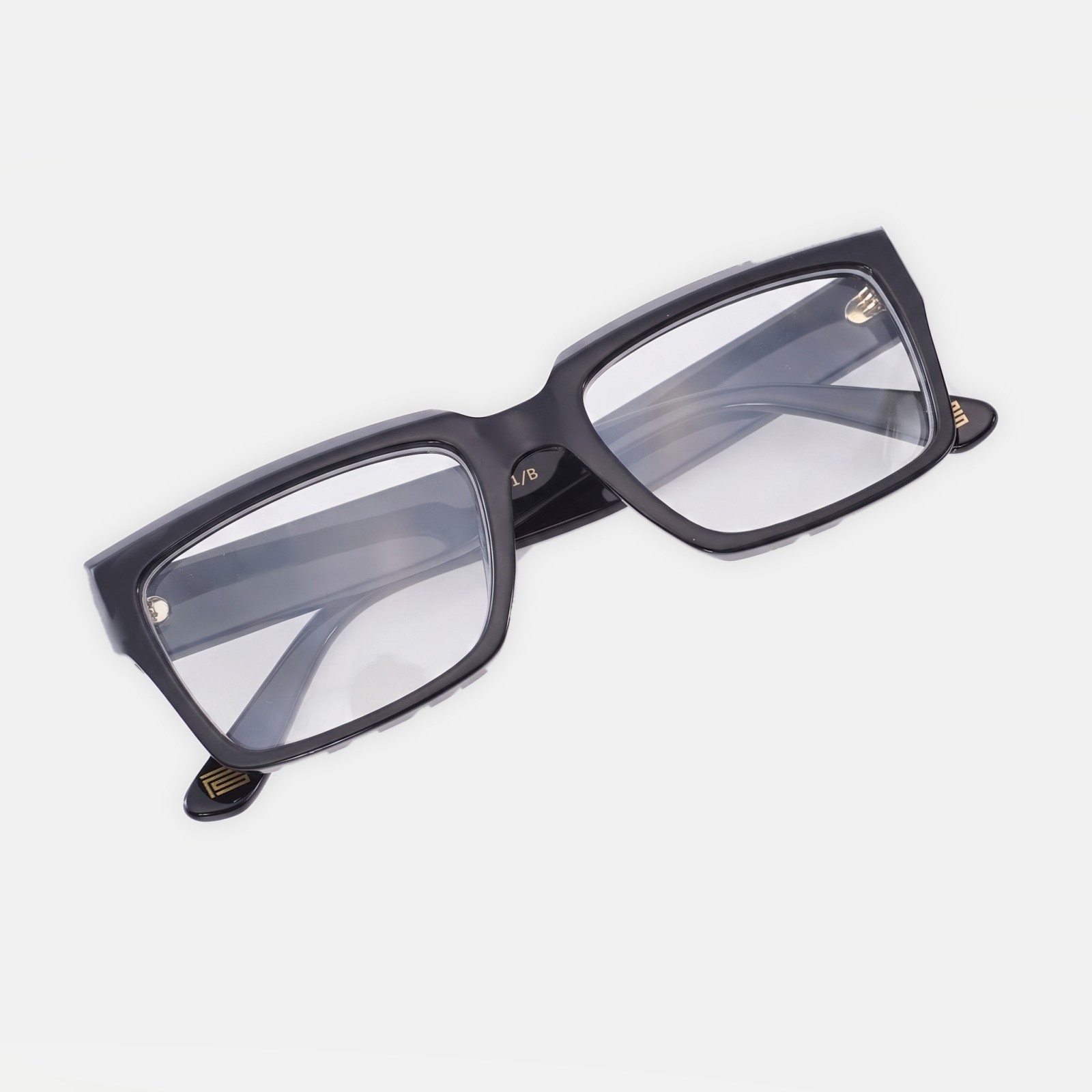 The Square PS001/B in Noir, with clear prescription lenses and the gold PS mark at the temple